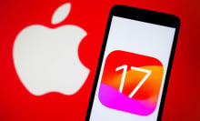 phone displaying ios 17 logo in front of backdrop showing apple logo